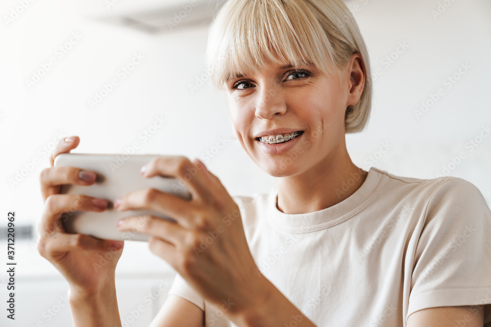 Smiling woman at the kitchen indoors at home Smiling woman at the kitchen indoors at home