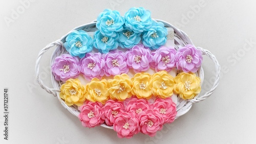 Artificial handmade flowers made out of beautiful fabric texture in pastel colors