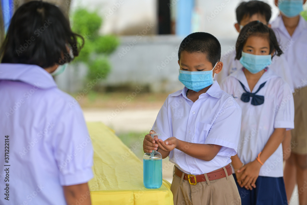 Washing Hand By Sanitizer Gel For Prevention Coronavirus Disease (Covid-19) in classroom.Washing hands by alcohol sanitizers or alcohol gel from pump bottle in public area.