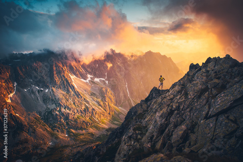 Man on the top of the hill watching wonderful scenery in mountains during summer colorful sunset in High Tatras in Slovakia.. © kovop58