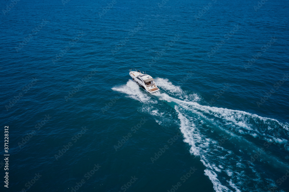 Top view of a white boat sailing to the blue sea. Motor boat in the sea.Travel - image
