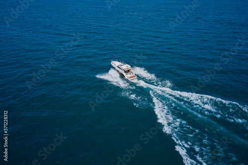 Top view of a white boat sailing to the blue sea. Motor boat in the sea.Travel - image © Berg