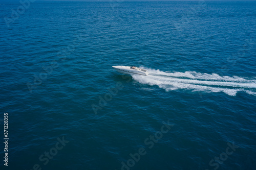 Top view of a white boat sailing to the blue sea. Side view. Motor boat in the sea.Travel - image.