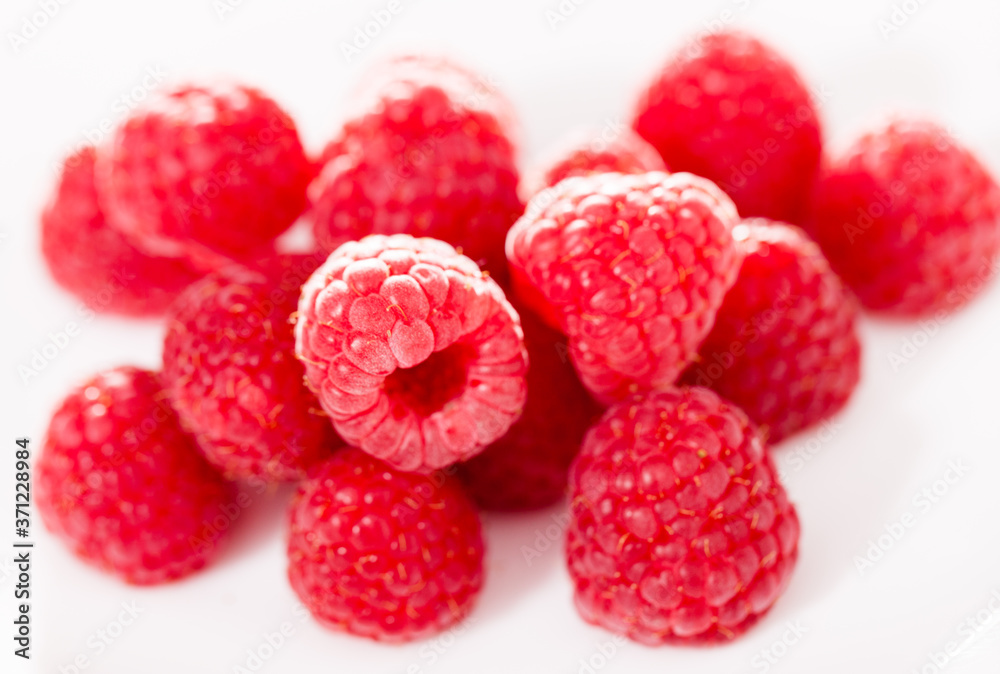 handful of raspberry berries on white background handful of raspberry berries on white background