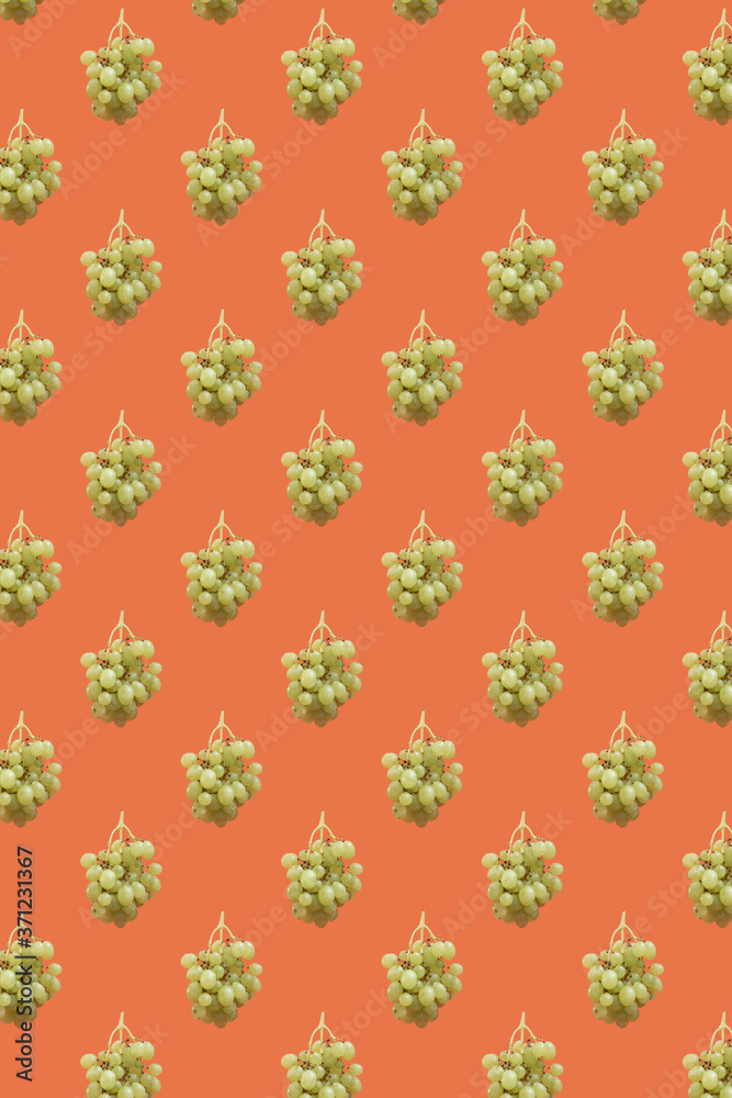Green grape bunch seamless pattern against orange background
