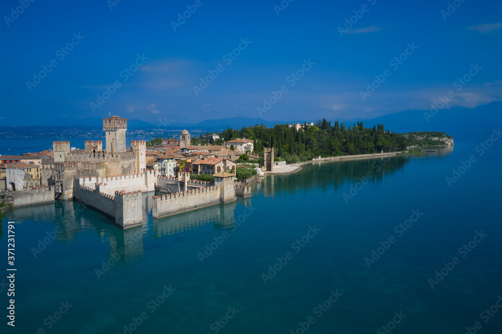 Sirmione, Lake Garda, Italy. The famous Sirmione Castle, good weather. Aerial view of the castle. Castle reflections in the water