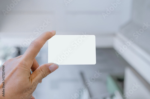 hand holding empty blank white business card mock up design text for advertisement branding.