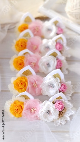Handmade flowers as headband hair accessory with cat or kitty ears as decoraiton in soft pastel colors
