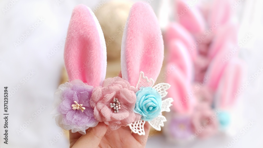 Handmade flowers as headband hair accessory with bunny or rabbit ears as decoration in soft pastel colors Handmade flowers as headband hair accessory with bunny or rabbit ears as decoration in soft pastel colors