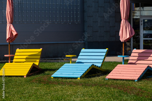 city sun loungers on green grass