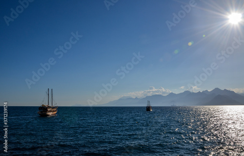 Excursion tourist boat against mountain range in the Mediterranean Sea  Antalya  Turkey