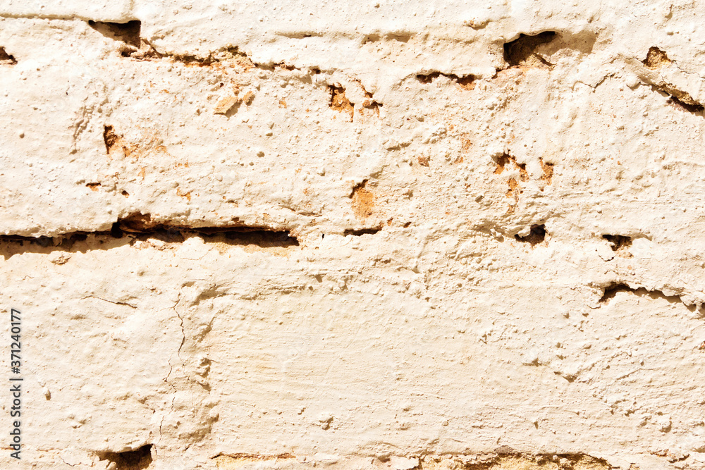 The texture of a brick wall painted with white paint. The texture of a brick wall painted with white paint.