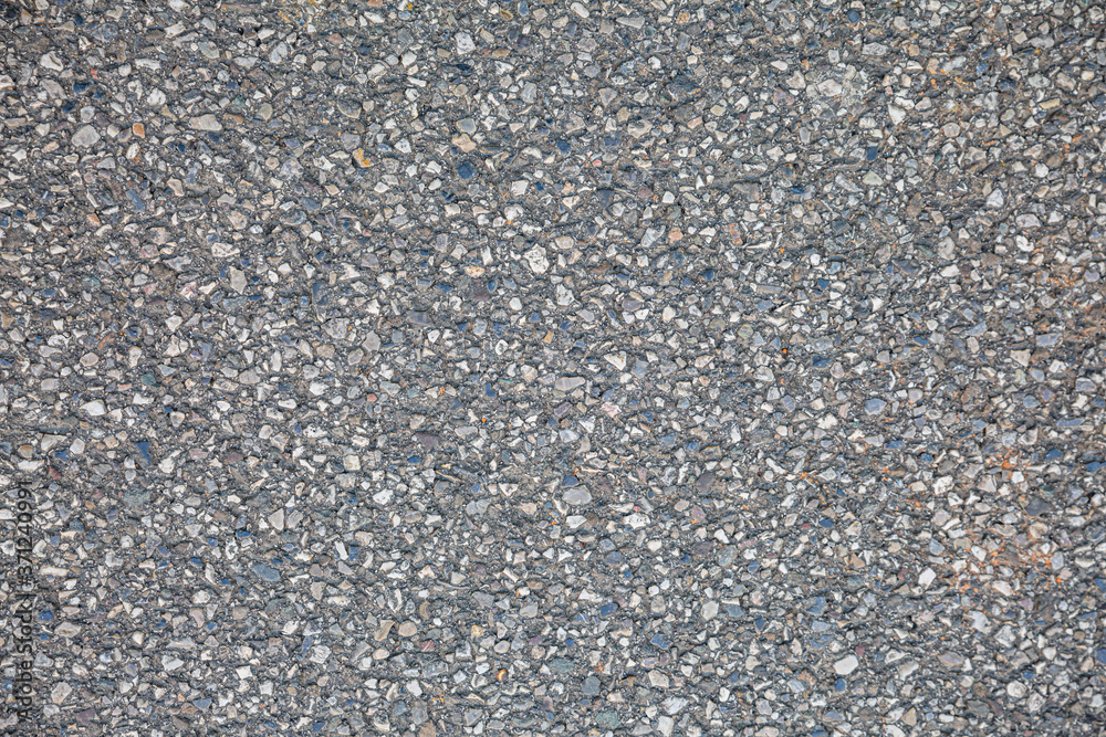 Stony surface of asphalt. Tarmac grey grainy road. Texture Background. Top view Stony surface of asphalt. Tarmac grey grainy road. Texture Background. Top view