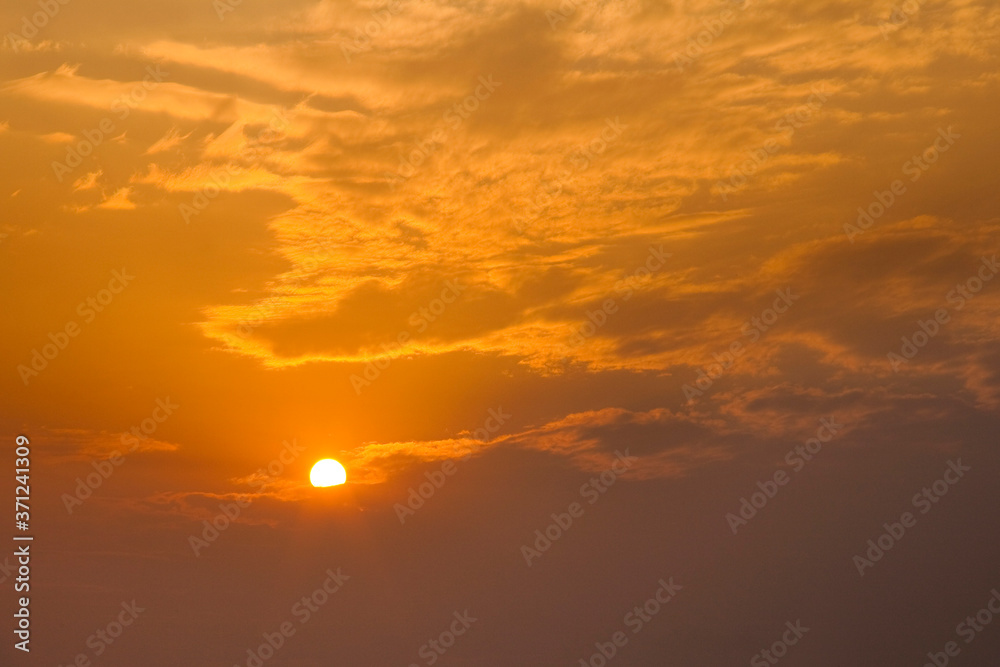 Colorful beautiful sunset with the orange cloud background