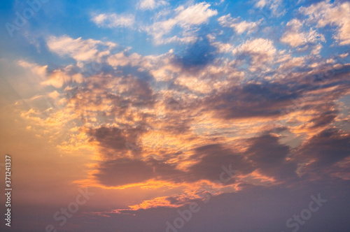 Colorful beautiful sunset with the orange cloud background