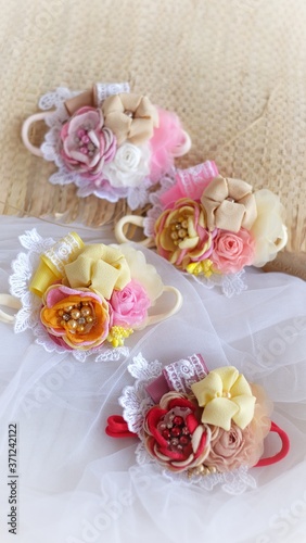 Handmade flower as headband hair accessory made out of fabric flowers in beautiful pastel colors