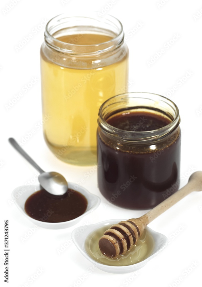 Honey and Treacle Jars against White Background Honey and Treacle Jars against White Background
