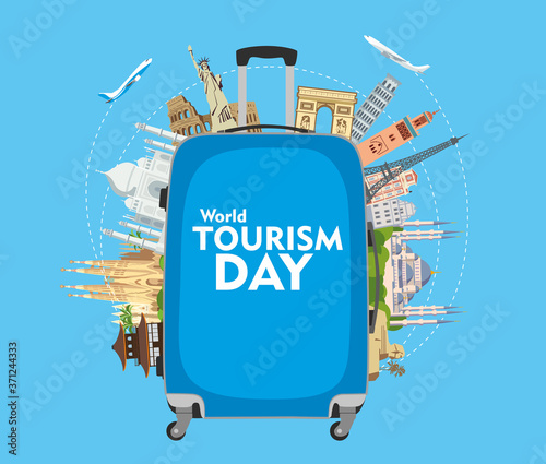 World Tourism Day. Congratulatory poster. The inscription on the blue travel suitcase. Around the monuments of architecture. Vector graphics