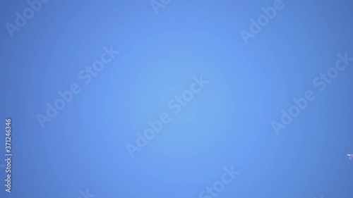 Aircraft Contrail Against Clear Blue Sky. Slow motion.