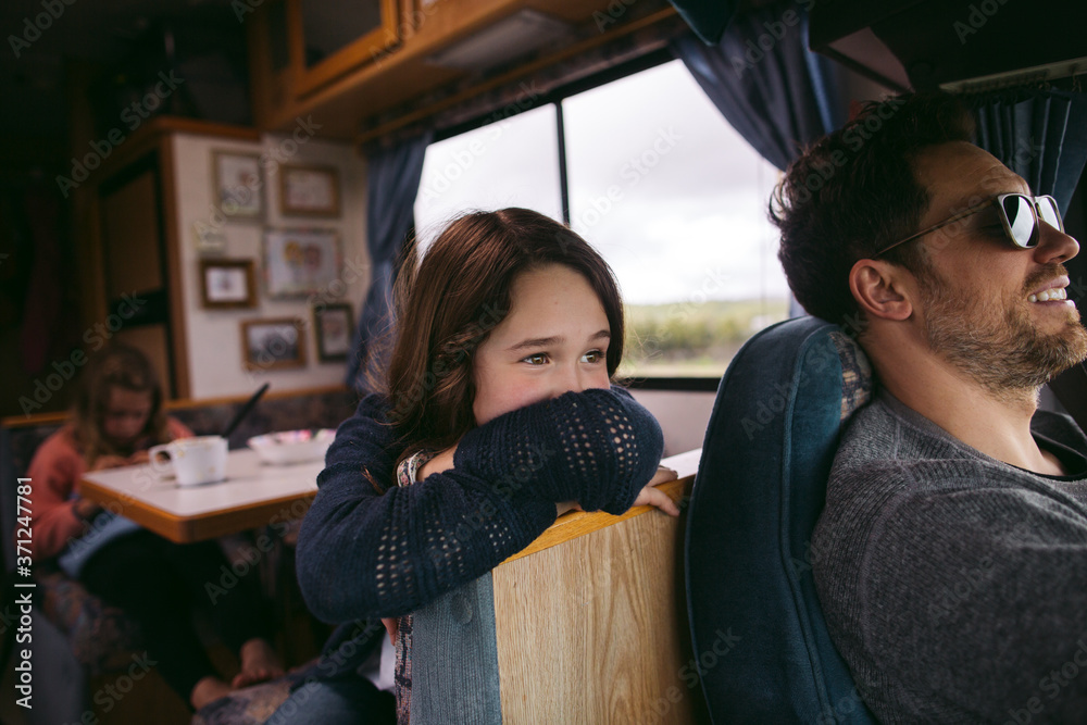 Girl looking out the window of motorhome on long road trip Stock Photo ...