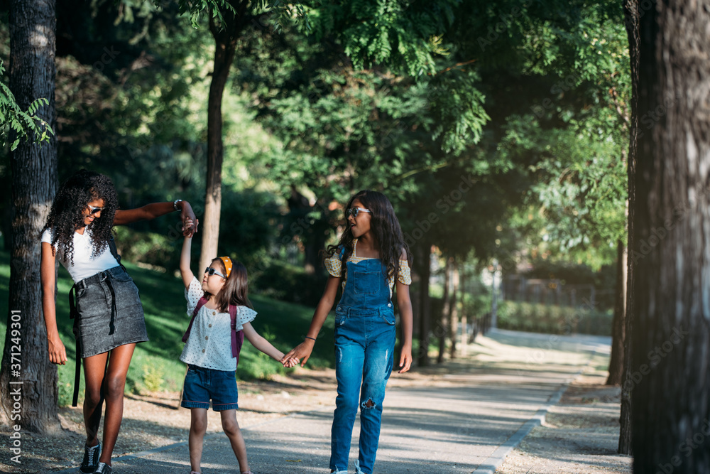 sisters and family holding hands while walking to school sisters and family holding hands while walking to school