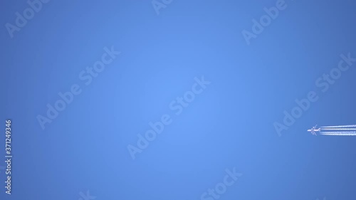 Aircraft Contrail Against Clear Blue Sky. Slow motion.