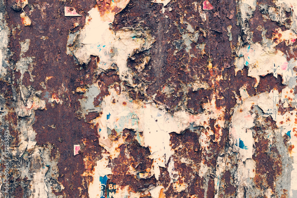 Fototapeta premium Creative metal background. Old metal background with scraps of paper ads. Flat background texture of dirty metal. As the main background for vintage design