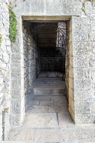 Italian architecture. Passageway, a door in a stone building. European old town.