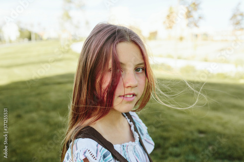 Teenage girl in sunlight with backpack