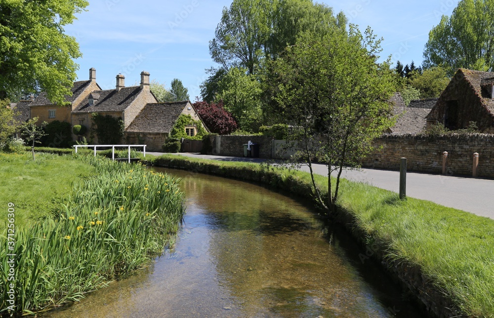 The River Eye running through the beautiful Cotswold village of Lower Slaughter, Gloucestershire, England. The River Eye running through the beautiful Cotswold village of Lower Slaughter, Gloucestershire, England.
