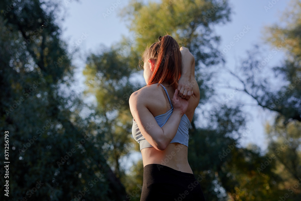 Redhead woman doing yoga in the nature. Redhead woman doing yoga in the nature.