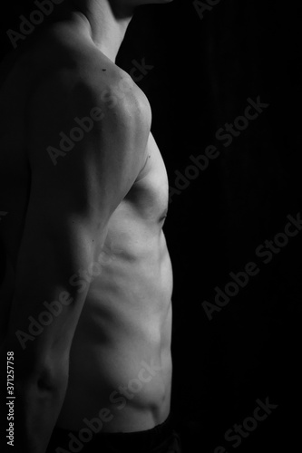 Medellín, Antioquia / Colombia. September 07, 2019. Muscular male torso on a black background 