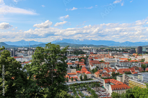 Landscape view over Ljubljana, with clouds and mountains in the background
