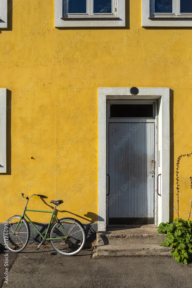 Bicycle against a colored wall in Copenhagen, Denmark Bicycle against a colored wall in Copenhagen, Denmark