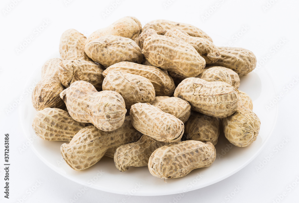 Close-up of delicious peanuts on a white dish Close-up of delicious peanuts on a white dish