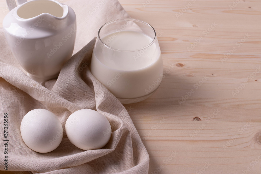 two white eggs and milk as calcium concept. minimalism style. two white eggs and milk as calcium concept. minimalism style.