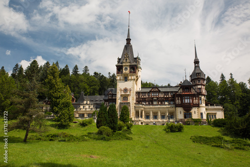 Panoramic view of Peles Castle, Romania. Famous Neo-Renaissance castle and ornamental garden in Sinaia, Carpathian Mountains in Europe.