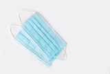 blue medical disposable masks on white surface, copy space