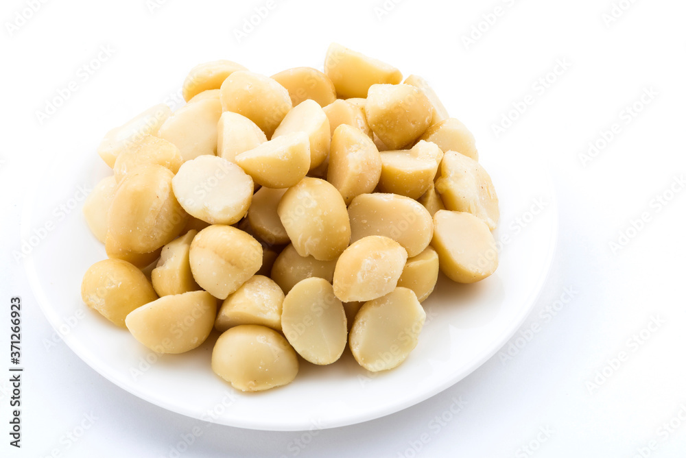 Close-up of delicious Macadamias on a white dish Close-up of delicious Macadamias on a white dish