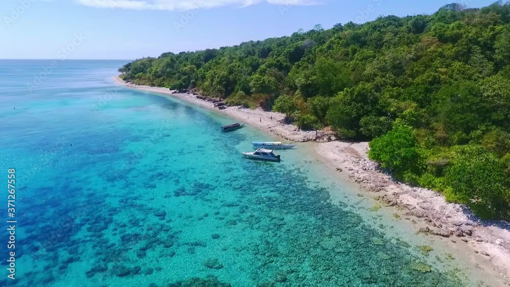 Aerial pull out shot over beautiful crystal clear beaches of Moyo island in Indonesia. Aerial pull out shot over beautiful crystal clear beaches of Moyo island in Indonesia.