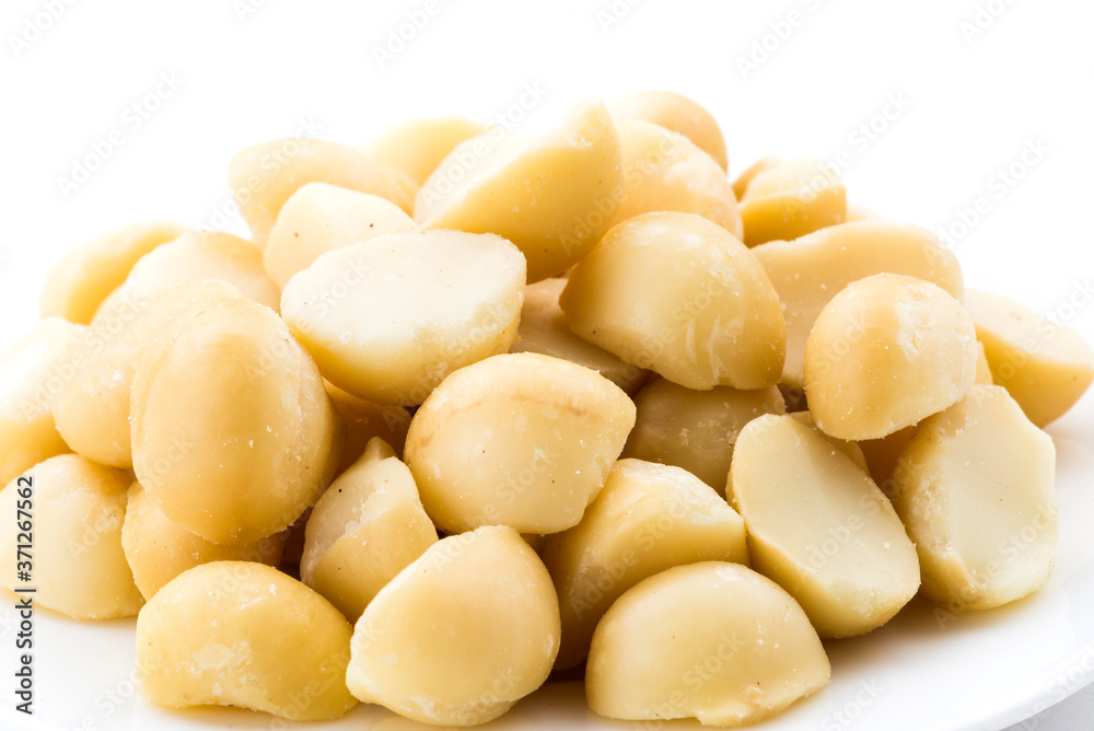 Close-up of delicious Macadamias on a white dish Close-up of delicious Macadamias on a white dish