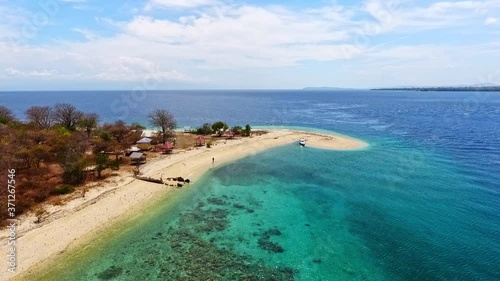 Forward aerial flight over tropical beaches and reefs of moyo island indonesia. photo