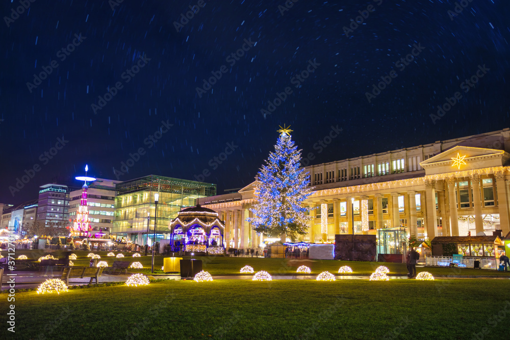 Illuminated Christmas tree and market fair on Castle square or Schlossplatz in German, Stuttgart
