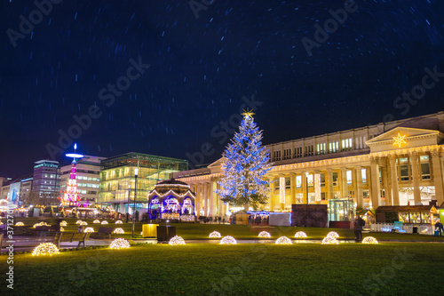 Illuminated Christmas tree and market fair on Castle square or Schlossplatz in German, Stuttgart photo