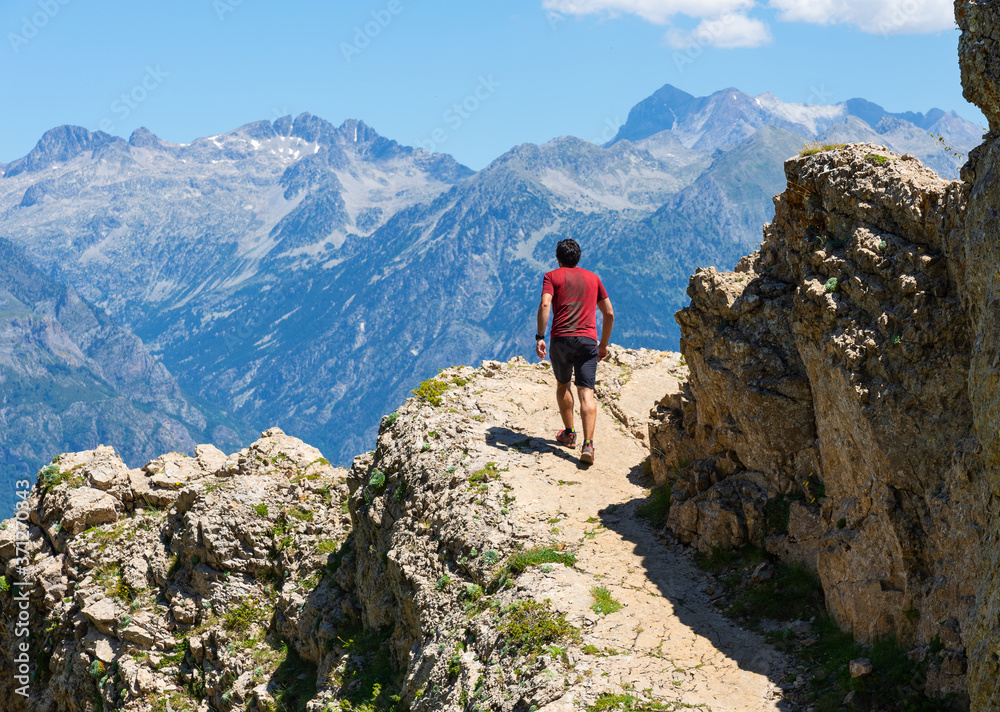 Male hiker climbing up a mountain. Active lifestyle concept.