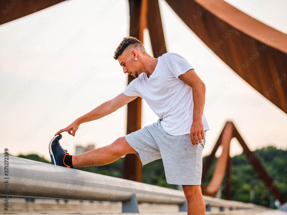 Shallow focus shot of a Caucasian male doing workout in a park