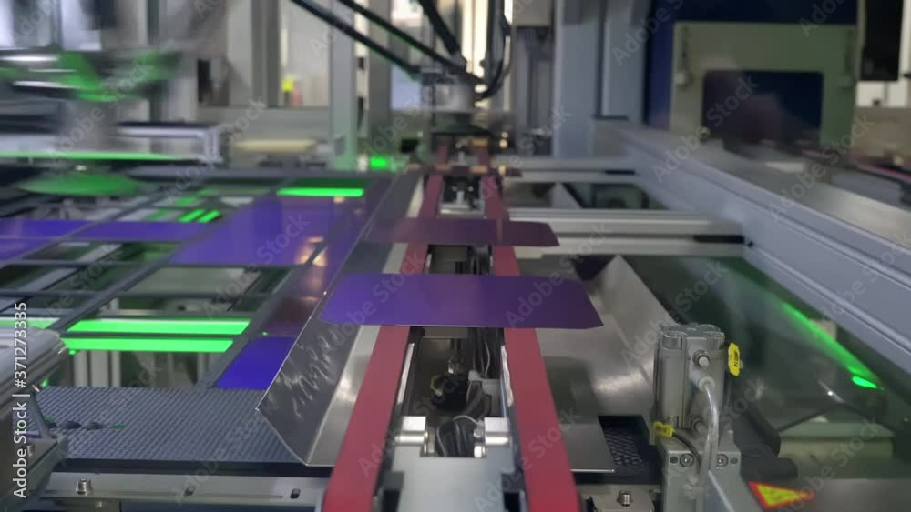 Robotic Arm Puts Solar Cells On The Conveyor Belt In Photovoltaic Factory Robotic Arm Puts Solar Cells On The Conveyor Belt In Photovoltaic Factory