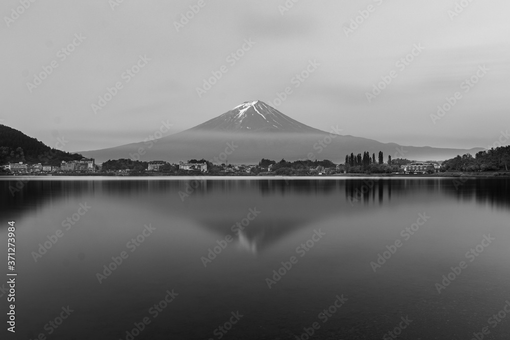 Mount fuji on a clear summer morning reflected on lake kawaguchi grayscale