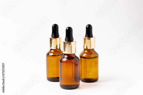 Amber Bottle for essential oils and cosmetic products. Glass bottle on white background. A dropper  a bottle with a sprayer