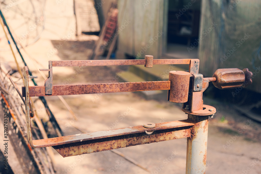 Ancient platform scales; wood and iron weighing machine. Selective focus. Tinted photograph. Ancient platform scales; wood and iron weighing machine. Selective focus. Tinted photograph.